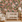 Nursery room with floral wallpaper, white crib, and beige armchair.
